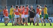 6 April 2014; Players from both Armagh and Donegal get involved in a tussle watched by referee Fergal Kelly. Allianz Football League, Division 2, Round 7, Armagh v Donegal, Athletic Grounds, Armagh. Picture credit: Brendan Moran / SPORTSFILE
