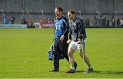 6 April 2014; Kerry's Darran O'Sullivan leaves the pitch on crutches alongside chartered physiotherapist Eddie Harnett. Allianz Football League, Division 1, Round 7, Kerry v Cork. Austin Stack Park, Tralee, Co. Kerry. Picture credit: Diarmuid Greene / SPORTSFILE