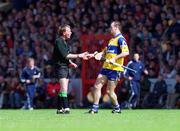 6 June 1999; Ollie Baker of Clare gives referee Dickie Murphy his substitution slip as he comes on as a substitute during the Guinness Munster Senior Hurling Championship Semi-Final match between Clare and Tipperary at Páirc Uí Chaoimh in Cork. Photo by Ray McManus/Sportsfile