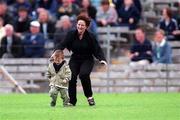 30 May 1999; A mother runs after her son after he decided to make an entrance onto the pitch during the Bank of Ireland Ulster Senior Football Championship Preliminary Round match between Monaghan and Fermanagh at St Tiernach's Park in Clones, Monaghan. Photo by Damien Eagers/Sportsfile