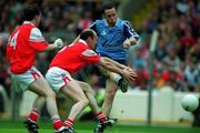6 June 1999; Ian Robertson of Dublin shoots to score his side's first goal despite the best efforts of Louth players Stephen Melia and Simon Gerrard, 4, during the Bank of Ireland Leinster Senior Football Championship Quarter-Final match between Dublin and Louth at Croke Park in Dublin. Photo by Brendan Moran/Sportsfile