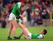 30 May 1999; Paul Brewster Fermanagh helps his team-mate Raymond Johnston with cramp during the Bank of Ireland Ulster Senior Football Championship Preliminary Round match between Monaghan and Fermanagh at St Tiernach's Park in Clones, Monaghan. Photo by Damien Eagers/Sportsfile