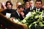 3 December 2005; George Best's agent Phil Hughes, centre, with Eamonn Holmes next to George Best's coffin in the Parliament buildings in Stormont, Belfast. Belfast, Co. Antrim. Picture credit: PA Pool / SPORTSFILE