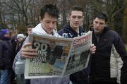 2 December 2005; George Best supporters read the days paper as they queue for the funeral of George Best. Belfast, Co. Antrim. Picture credit: Damien Eagers / SPORTSFILE