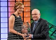 2 March 2014; Louise Quinn, from Blessington, Co. Wicklow, and playing for Eskilstuna United, Sweden, is presented with the Women's senior International player of the year award by FAI president Paddy McCaul. Three FAI International Football Awards, RTE Studios, Donnybrook, Dublin. Picture credit: David Maher / SPORTSFILE