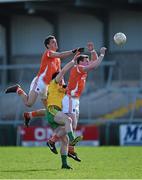 6 April 2014; Stephen Harold, left, and Kieran Toner, Armagh, contest a kickout with David Walsh, Donegal. Allianz Football League, Division 2, Round 7, Armagh v Donegal, Athletic Grounds, Armagh. Picture credit: Brendan Moran / SPORTSFILE