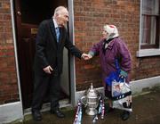8 December 2005; Founder member of Drogheda United Football Club, Tom Munster, aged 91, at his home in Drogheda, Co. Louth, greets his local neighbour Mary Dunne with the FAI Carlsberg Cup. Drogheda, Co. Louth. Picture credit: David Maher / SPORTSFILE