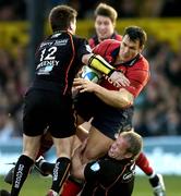 10 December 2005; Trevor Halstead, Munster, is tackled by Ceri Sweeney, 12, and Jon Bryant, Newport Gwent Dragons. Heineken Cup 2005-2006, Pool 1, Munster v Newport Gwent Dragons, Rodney Parade, Newport, Wales. Picture credit: Matt Browne / SPORTSFILE
