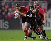 17 December 2005; Ronan O'Gara, Munster, is tackled by Garaeth Baber, Newport Gwent Dragons. Heineken Cup 2005-2006, Pool 1, Round 4, Munster v Newport Gwent Dragons, Thomond Park, Limerick. Picture credit: Kieran Clancy / SPORTSFILE