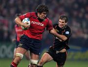 17 December 2005; Donncha O'Callaghan, Munster, is tackled by Gareth Baber, Newport Gwent Dragons. Heineken Cup 2005-2006, Pool 1, Round 4, Munster v Newport Gwent Dragons, Thomond Park, Limerick. Picture credit: Kieran Clancy / SPORTSFILE