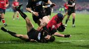 17 December 2005; Anthony Foley, Munster, goes over for a try despite the attention of Richard Fussell, Newport Gwent Dragons. Heineken Cup 2005-2006, Pool 1, Round 4, Munster v Newport Gwent Dragons, Thomond Park, Limerick. Picture credit: Kieran Clancy / SPORTSFILE