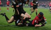 17 December 2005; Anthony Foley, Munster, goes over for a try despite the attention of Richard Fussell, Newport Gwent Dragons. Heineken Cup 2005-2006, Pool 1, Round 4, Munster v Newport Gwent Dragons, Thomond Park, Limerick. Picture credit: Kieran Clancy / SPORTSFILE