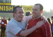 25 December 2005; Greg Ryan, from Deansgrange, Dublin, hugs his friend Nap Keeling, Donnybrook, Dublin, after 'competing' in one of the many Goal Miles during the Annual Goal Mile run. Belfield, Dublin. Picture credit: Ray McManus / SPORTSFILE