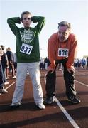 25 December 2005; Patrick Crowley, 12 years, from Roebuck, Dublin, and his Dad Eric relax after 'competing' in one of the many Goal Miles during the Annual Goal Mile run. Belfield, Dublin. Picture credit: Ray McManus / SPORTSFILE