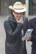 26 December 2005; U2 singer Bono checks out the race card. Leopardstown Racecourse, Co. Dublin. Picture credit: Pat Murphy / SPORTSFILE