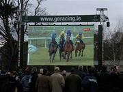 26 December 2005; Leopardstown racegoers watch a large screen TV showing  Kicking King, second from right, in action during the King George V Chase. Leopardstown Racecourse, Co. Dublin. Picture credit: Pat Murphy / SPORTSFILE
