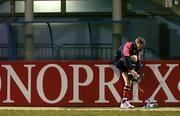 12 January 2006; Out-half Ronan O'Gara puts on his boots before the Munster squad's kicking practice. Stade Pierre Antoine, Castres, France. Picture credit: Brendan Moran / SPORTSFILE