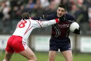 15 January 2006; Conal Martin, St. Mary's College Belfast, is tackled by Colin Holmes, Tyrone. Dr McKenna Cup, Tyrone v St. Mary's College Belfast. Coalisland, Co. Tyrone. Picture credit: Oliver McVeigh / SPORTSFILE