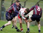 15 January 2006; Dermot Carlin, Tyrone, is tackled by Gareth O'Neill and Conal Martin, St. Mary's College Belfast. Dr McKenna Cup, Tyrone v St. Mary's College Belfast. Coalisland, Co. Tyrone. Picture credit: Oliver McVeigh / SPORTSFILE