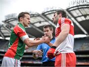 13 April 2014; Mayo captain Andy Moran shakes with Derry captain Mark Lynch with referee Padraig Hughes before the start of the game. Allianz Football League Division 1 Semi-Final, Derry v Mayo, Croke Park, Dublin. Picture credit: David Maher / SPORTSFILE