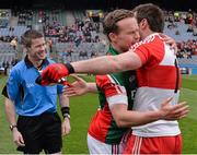 13 April 2014; Mayo captain Andy Moran and Derry captain Mark Lynch, right, embrace in front of match referee Padraig Hughes before the game. Allianz Football League Division 1 Semi-Final, Derry v Mayo, Croke Park, Dublin. Picture credit: Ray McManus / SPORTSFILE