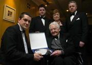 13 January 2006; Former radio broadcaster Philip Greene acompanied by his his wife Patricia and sons Eoin, back left, and Philip Jr., back right, is presented with his Special Merit award for his remarkable services to sport at the eircom / SWAI Player of the Year Awards by Aiden Fitzmaurice, left, President of the eircom / Soccer Writers Association of Ireland. Alexander Hotel, Dublin. Picture credit: Pat Murphy / SPORTSFILE