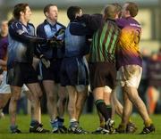 15 January 2006; Referee Gabriel McKenny attempts to break up a tussle between Dublin and Wexford players. O'Byrne Cup, Second Round, Dublin v Wexford, O'Toole's GAA Club, Ayrefield Park, Coolock, Dublin. Picture credit: Brian Lawless / SPORTSFILE