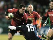 13 January 2006; Ian Dowling, Munster, is tackled by Castres Olympique. Heineken Cup 2005-2006, Pool 1, Round 5, Castres Olympique v Munster, Stade Pierre Antoine, Castres, France. Picture credit: Brendan Moran / SPORTSFILE