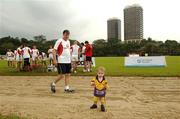 20 January 2006; Donal O'Grady walks past a possible star of the future three year old Ruaidhri Newille, from Hong Kong, in advance of the 2006 Vodafone All-Stars Hurling game. Singapore Polo Club, Singapore. Picture credit; Ray McManus / SPORTSFILE