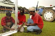 20 January 2006; Staff of the Polo Club, Binu, Surgsh and Satesh, all from India, tie the nets before erecting the goal posts before training in advance of the 2006 Vodafone All-Stars Hurling game. Singapore Polo Club, Singapore. Picture credit; Ray McManus / SPORTSFILE