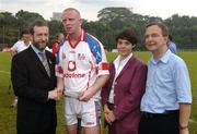 21 January 2006; John Mullane, Waterford, who captained the 2005 Vodafone All-Stars team, is presented with a commerative medal by GAA President Sean Kelly in the company of Helen Marks, Head of Brand and Marcomms, Vodafone Ireland and Minister for Transport Martin Cullen, T.D., after the game. Exhibition Game, 2004 Vodafone All-Stars v 2005 Vodafone All-Stars, Singapore Polo Club, Singapore. Picture credit; Ray McManus / SPORTSFILE