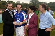 21 January 2006; Davy Fitzgerald, Clare, who played on the 2005 Vodafone All-Stars team, is presented with a commerative medal by GAA President Sean Kelly in the company of Helen Marks, Head of Brand and Marcomms, Vodafone Ireland and Minister for Transport Martin Cullen, T.D., after the game. Exhibition Game, 2004 Vodafone All-Stars v 2005 Vodafone All-Stars, Singapore Polo Club, Singapore. Picture credit; Ray McManus / SPORTSFILE
