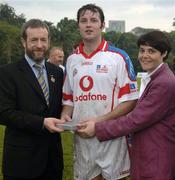 21 January 2006; Paul Kelly, Tipperary, who played on the 2005 Vodafone All-Stars team, is presented with a commerative medel by GAA President Sean Kelly in the company of Helen Marks, Head of Brand and Marcomms, Vodafone Ireland, after the game. Exhibition Game, 2004 Vodafone All-Stars v 2005 Vodafone All-Stars, Singapore Polo Club, Singapore. Picture credit; Ray McManus / SPORTSFILE