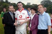 21 January 2006; Eoin Larkin, Kilkenny, who played on the 2005 Vodafone All-Stars team, is presented with a commerative medal by GAA President Sean Kelly in the company of Helen Marks, Head of Brand and Marcomms, Vodafone Ireland and Minister for Transport Martin Cullen, T.D., after the game. Exhibition Game, 2004 Vodafone All-Stars v 2005 Vodafone All-Stars, Singapore Polo Club, Singapore. Picture credit; Ray McManus / SPORTSFILE