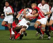 27 January 2006; Isaac Boss, Ulster, is tackled by Martyn Madden and Inoke Afeaki, Llanelli Scarlets. Celtic League 2005-2006, Group A, Ulster v Llanelli Scarlets, Ravenhill, Belfast. Picture credit: Oliver McVeigh / SPORTSFILE