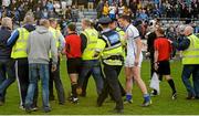19 April 2014; Referee Derek O'Mahoney is escorted off the field after the game, surrounded by protestations from Cavan players, officials and fans. Cadbury GAA Football U21 Championship Semi-Final, Cavan v Dublin, O'Moore Park, Portlaoise, Co. Laois. Picture credit: Piaras Ó Mídheach / SPORTSFILE