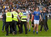 19 April 2014; Referee Derek O'Mahoney is escorted off the field after the game, surrounded by protestations from Cavan players, officials and fans. Cadbury GAA Football U21 Championship Semi-Final, Cavan v Dublin, O'Moore Park, Portlaoise, Co. Laois. Picture credit: Piaras Ó Mídheach / SPORTSFILE