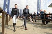 21 April 2014; Jockeys Eddie O'Connell, left, and Bryan Cooper make their way from the course after watching the Rathbarry & Glenview Studs Handicap Hurdle. Fairyhouse Easter Festival, Fairyhouse, Co. Meath. Picture credit: Barry Cregg / SPORTSFILE