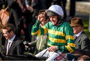 21 April 2014; Jockey Barry Geraghty celebrates as he is lead into the winners enclosure on Shutthefrontdoor after winning the Boylesports Irish Grand National Steeplechase. Fairyhouse Easter Festival, Fairyhouse, Co. Meath. Picture credit: Barry Cregg / SPORTSFILE