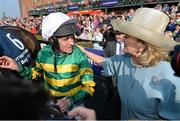 21 April 2014; Jockey Barry Geraghty celebrates with Noreen McManus, wife of owner JP McManus, after winning the Boylesports Irish Grand National Steeplechase with Shutthefrontdoor. Fairyhouse Easter Festival, Fairyhouse, Co. Meath. Picture credit: Brendan Moran / SPORTSFILE