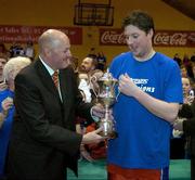 29 January 2006; UCC Demons captain Niall O'Reilly is presented with the cup by Toly Colgan, President, Basketball Ireland. Superleague Men's Cup Final, UCC Demons v Limerick Lions, National Basketball Arena, Tallaght, Dublin. Picture credit: Brendan Moran / SPORTSFILE
