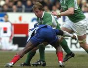 11 February 2006; Jerry Flannery, Ireland, is tackled by Yannick Nyanga, France. RBS 6 Nations 2006, France v Ireland, Stade de France, Paris, France. Picture credit; Matt Browne / SPORTSFILE