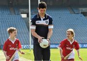 29 April 2014; Rory O'Carroll Dublin, demonstrates his skills to Sean Hosford, age 8, and Siun McFerran, age 6, both from Dublin, in attendance at the launch of the Kellogg’s GAA Cúl Camps 2014. Research commissioned by Kellogg’s to celebrate the 2014 launch, found that Gaelic games continue to enjoy huge popularity in Ireland with 73% of families devoting more than 10 hours per month to GAA sports. Croke Park, Dublin. Picture credit: David Maher / SPORTSFILE