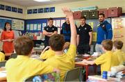 30 April 2014; Leinster Rugby stars, from left, Noel Reid, Darragh Fanning, Brendan Macken and Rob Kearney were on hand at St Patrick’s Boys National School, Hollypark, Blackrock in Dublin today to help out with a surprise training session for some of the school children to mark the launch of The Herald Leinster Rugby Summer Camps which run in venues across the province throughout July and August. At the launch of the Leinster Rugby Summer Camps in St. Patrick’s Boys National School, Hollypark, Blackrock, Dublin, is Leinster's Eoin Reddan being tackled by 4th class pupil Patrick van Zuydam. Picture credit: Stephen McCarthy / SPORTSFILE