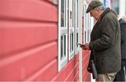 30 April 2014; A general view of a racegoer purchasing his racecard ahead of the day's races. Punchestown Racecourse, Punchestown, Co. Kildare. Picture credit: Barry Cregg / SPORTSFILE