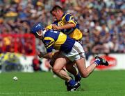 6 June 1999; Alan Markham of Clare in action against Fergal Heaney of Tipperary during the Guinness Munster Senior Hurling Championship semi-final match between Clare and Tipperary at Páirc Uí Chaoimh in Cork. Photo by Ray McManus/Sportsfile