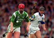 30 May 1999; Brian Begley of Limerick  in action against Paul Flynn of Waterford during the Guinness Munster Senior Hurling Championship quarter-final match between Limerick and Waterford at Páirc Uí Chaoimh in Cork. Photo by Ray McManus/Sportsfile