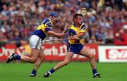 6 June 1999; Brian Quinn of Clare in action against Conal Bonnar of Tipperary during the Guinness Munster Senior Hurling Championship semi-final match between Clare and Tipperary at Páirc Uí Chaoimh in Cork. Photo by Ray McManus/Sportsfile