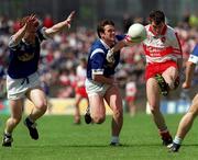 20 June 1999; Joe Brolly of Derry in action against Peter Reilly and Gerry Sheridan of Cavan during the Bank of Ireland Ulster Senior Football Championship quarter-final match between Cavan and Derry at Breffni Park in Cavan. Photo by Damien Eagers/Sportsfile