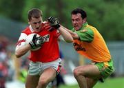 13 June 1999; Paddy McKeever of Armagh is tackled by Damien Diver of Donegal during the Bank of Ireland Ulster Senior Football Championship quarter-final replay match between Armagh and Donegal at St Tiernach's Park in Clones, Monaghan. Photo by Ray Lohan/Sportsfile *** Local Caption ***